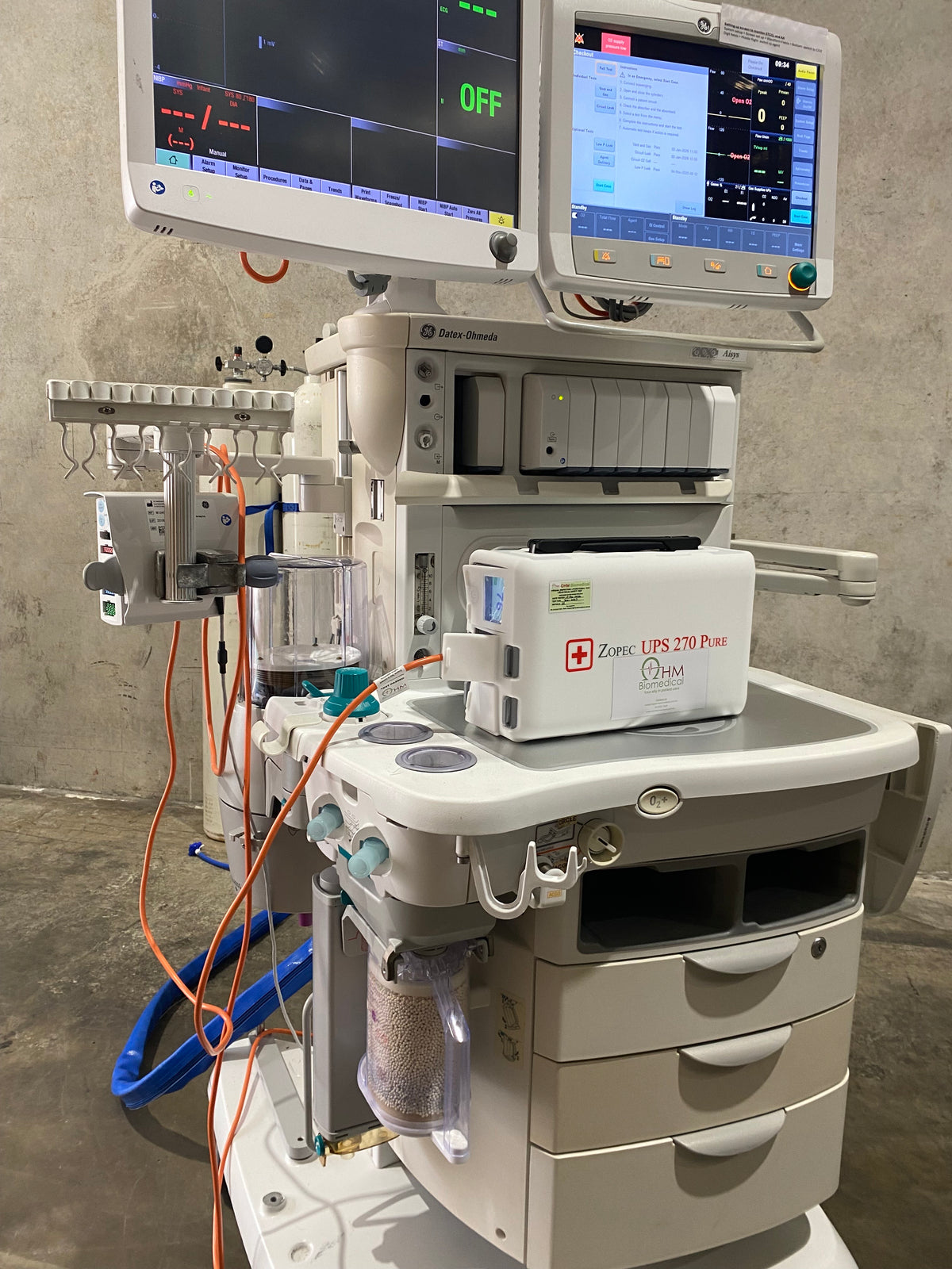 Biomedical engineer with Zopec medical UPS on service trolley